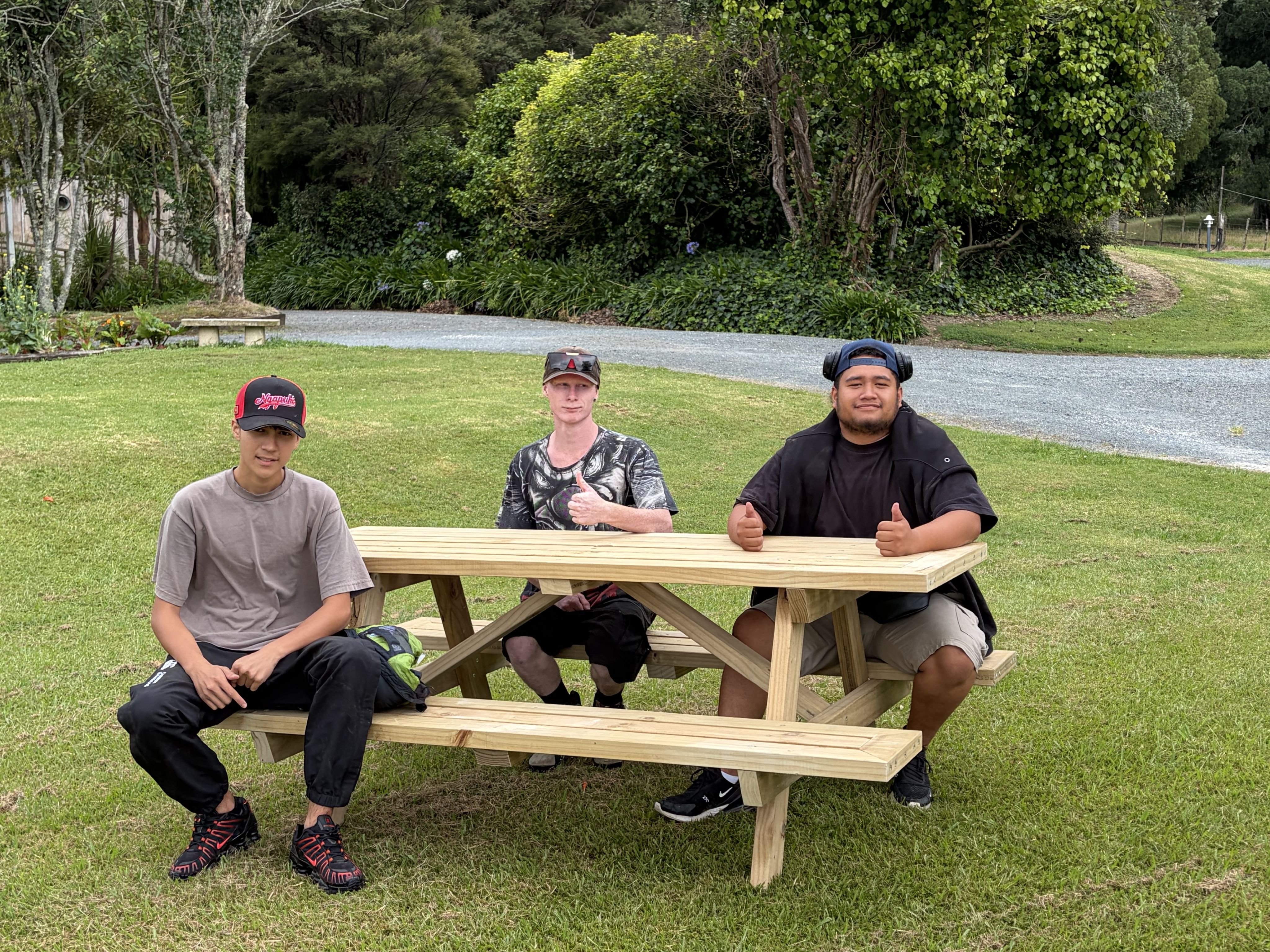 a man and a woman sitting at a table with a laptop