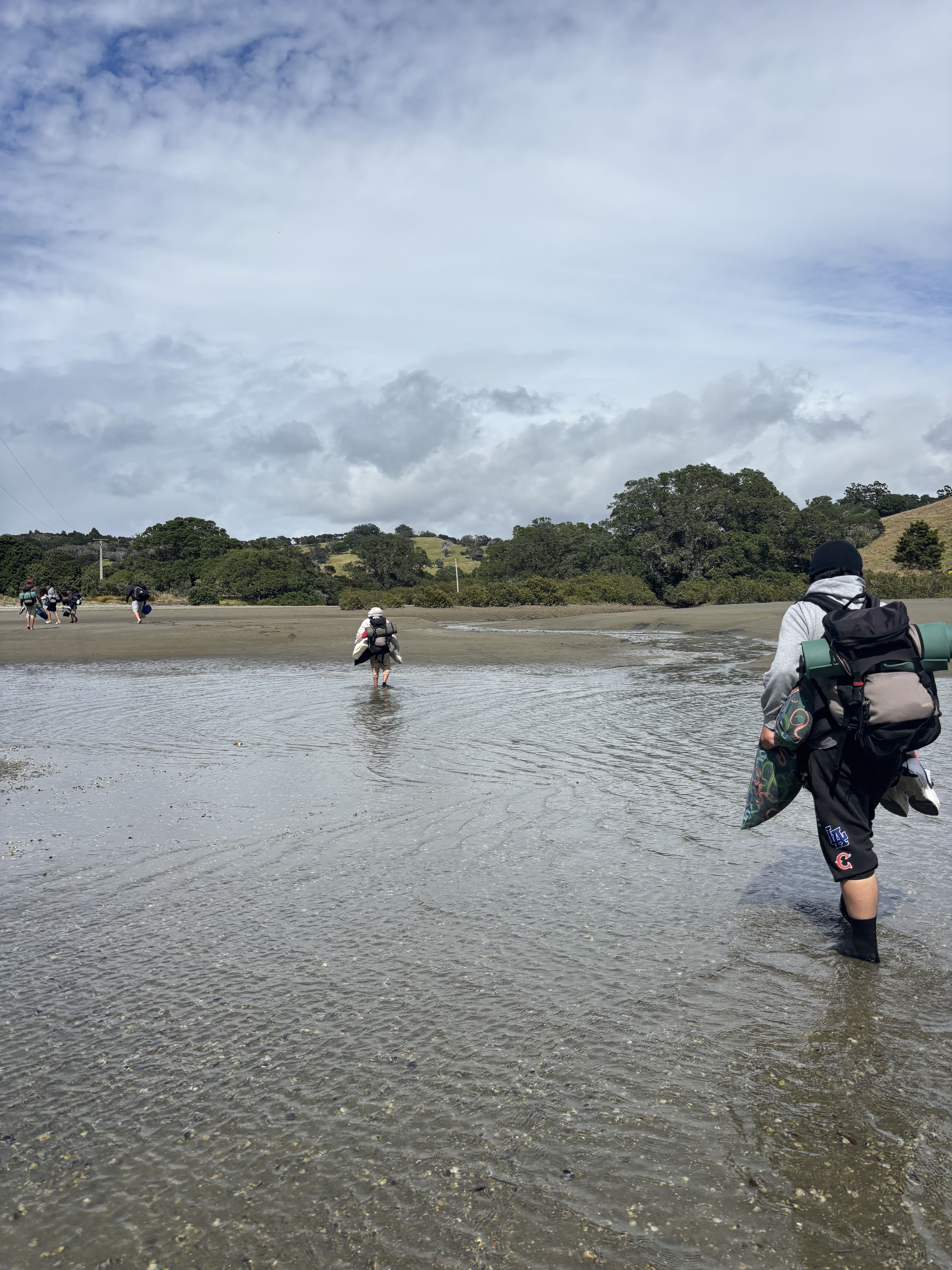 Students crossing the river at low tide