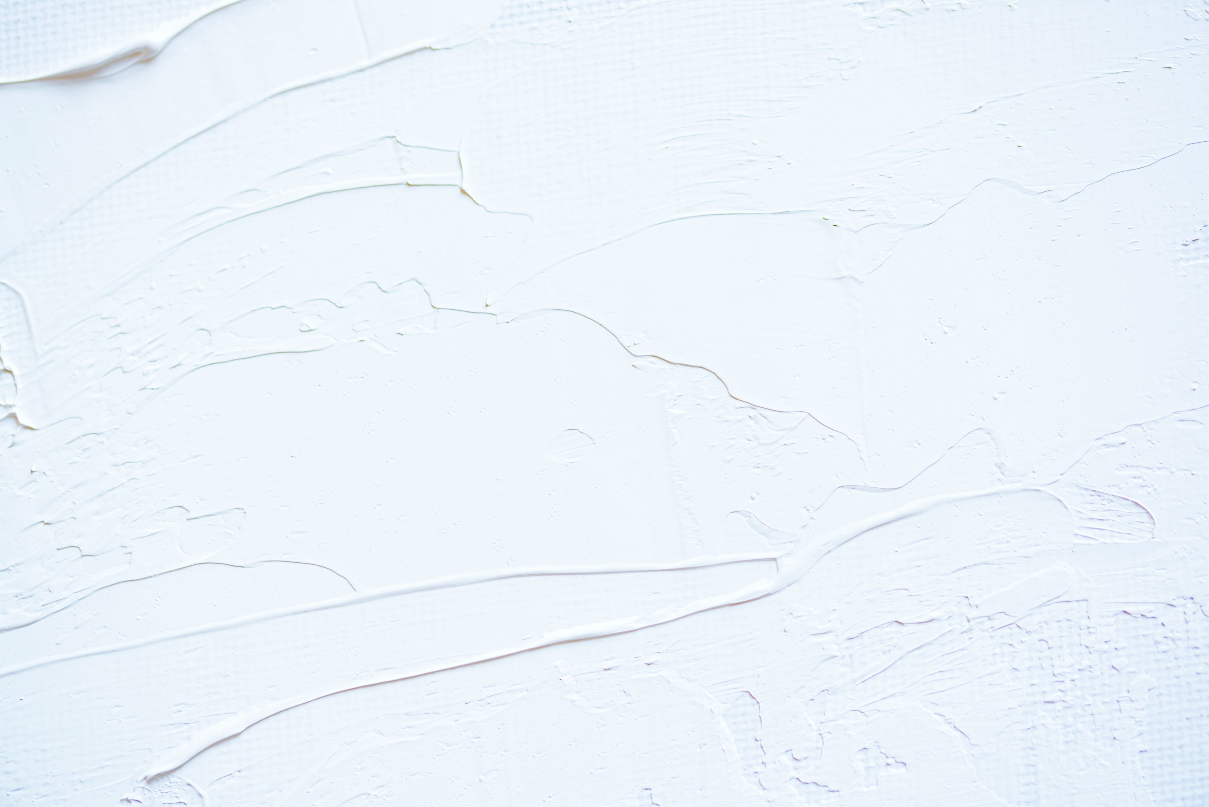 a close up of a white wall with peeling paint